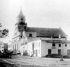 an old black and white photo of a building with a clock tower