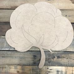 a paper tree cut out on top of wood