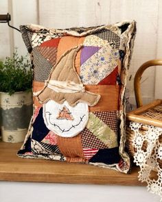 a decorative pillow is sitting on a shelf next to a wicker basket and potted plant