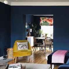 a living room with blue walls and wooden floors