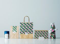 an assortment of paper bags and packaging on a white table with a blue canister