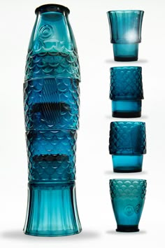 four blue glass vases with different shapes and sizes in front of each other on a white background