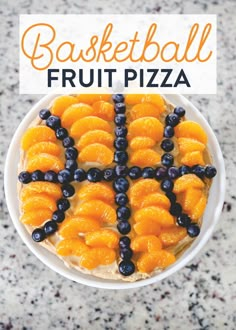 an overhead view of a fruit pizza with blueberries and oranges on the top