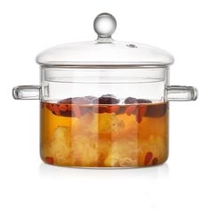 an image of a glass pot with ice and tea in it on a white background