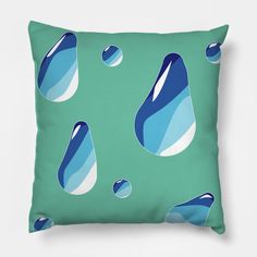 a green pillow with blue and white water drops on the front, against a teal background