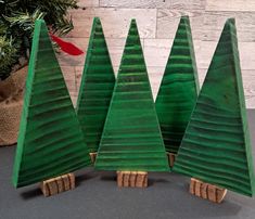 three green wooden christmas trees sitting next to each other