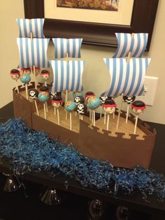 a cake that is shaped like a pirate ship with blue and white decorations on it