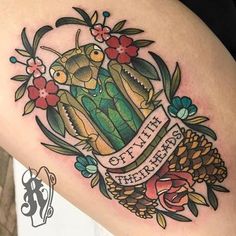 a woman's thigh with an alligator and pineapple tattoo on it