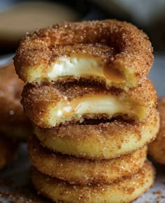 several donuts stacked on top of each other with icing and powdered sugar