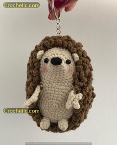 a crocheted keychain with a small stuffed animal in the shape of a hedge