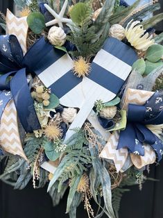 a wreath decorated with blue and white ribbons