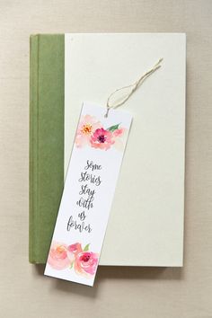 a bookmark that says some stories stay with us forever on it next to an open book