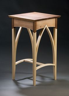 a small wooden table on a grey background