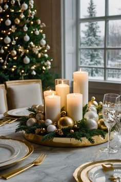 Elevate your holiday table with a glamorous gold and white centerpiece featuring candles, ornaments, and touches of greenery for a classic, upscale look. Christmas Round Centerpieces, Christmas Ornaments Centerpieces, Christmas Centerpieces Round Table, Round Table Centerpieces Christmas, Christmas Centerpiece Round Table, Christmas Ornament Centerpieces, Green And Gold Centerpieces, White And Gold Christmas Table, Christmas Centerpieces For Round Tables