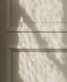 the shadow of a person's hand on a door