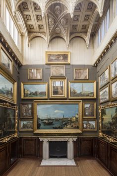 a large room with many paintings on the wall