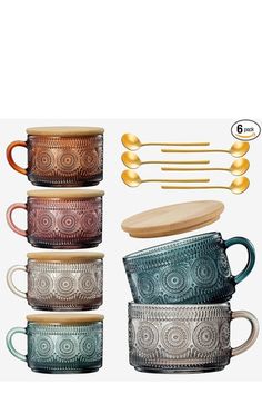 four different colored mugs with spoons and forks