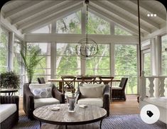 a living room filled with furniture and windows