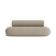 a beige couch sitting on top of a white floor