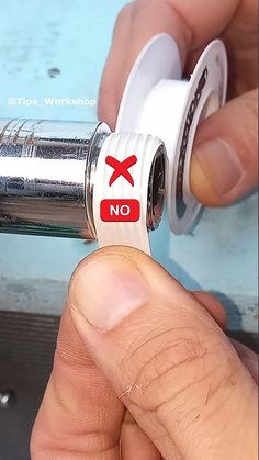 a person is holding a lighter with the word no on it in red and white