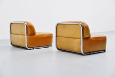 an orange chair and ottoman sitting next to each other on a white floor in front of a wall