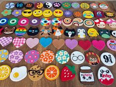 a table topped with lots of different decorated cookies and pastries on top of wooden boards