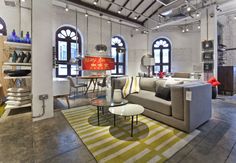 a living room filled with furniture and lots of windows