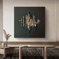 an abstract painting hangs on the wall above a table