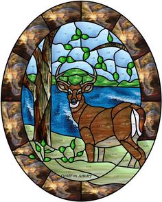 a stained glass window with a deer standing next to a tree