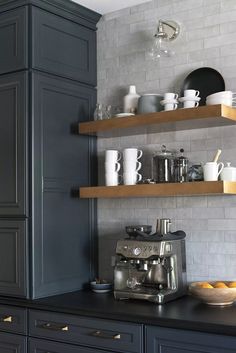 the shelves in this kitchen are filled with dishes and cups, along with other items