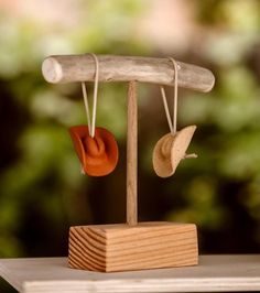 a wooden stand with two hats hanging from it