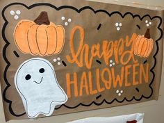 a halloween bulletin board with ghost and pumpkins on it's side, along with the words happy halloween