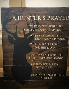 a wooden sign with a deer's head and poem written in black on it