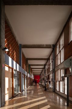 two people sitting on the floor in an empty building