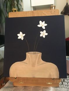 an easel with some flowers in it