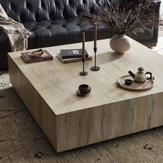 a coffee table with some books and cups on it