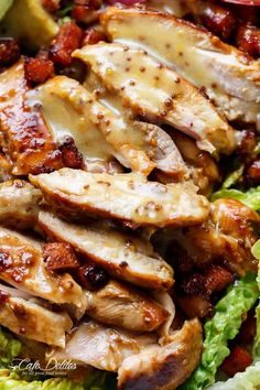 chicken and lettuce salad with sauce on top is ready to be eaten for lunch