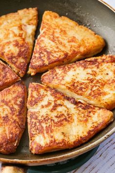 several pieces of cheese pizza in a frying pan