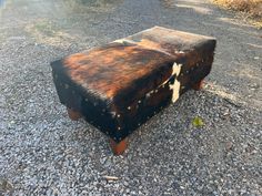 an old trunk is sitting on the gravel