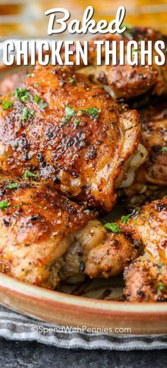 baked chicken thighs on a plate with parsley in the foreground and text overlay that reads baked chicken thighs