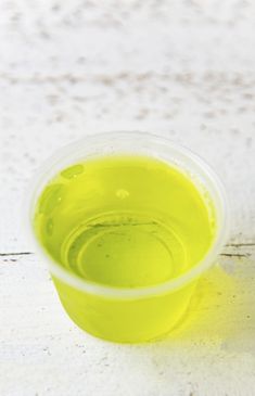 a yellow cup sitting on top of a white table