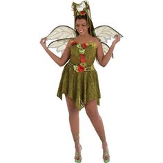 a woman in a green fairy costume with flowers on her chest and wings, posing for the camera