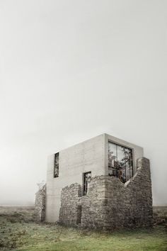 a house made out of bricks sitting on top of a grass covered field