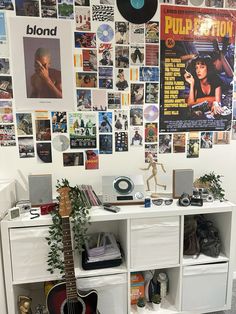 a guitar is sitting on top of a white shelf