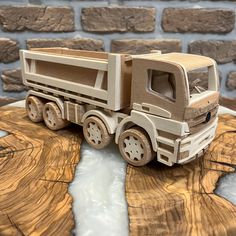 a wooden model of a dump truck on a table