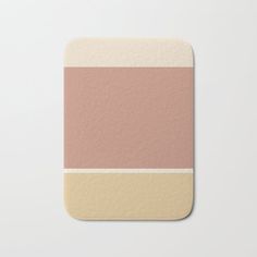 a pink and beige striped coaster on a white surface with the color block in it