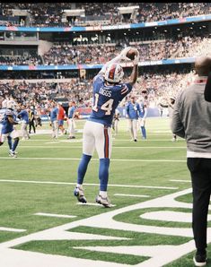 a football player jumping up into the air