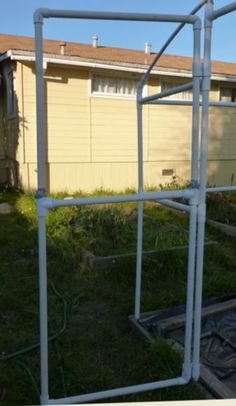 the back side of a house that is being constructed with metal pipes and plastic tubes