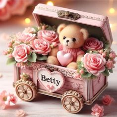 a teddy bear in a pink carriage with roses