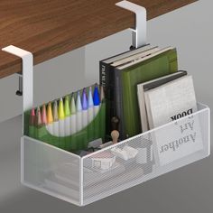 a desk with some books and pencils in a bin on the shelf next to it